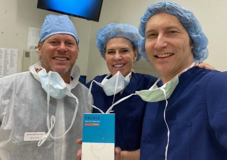 Dr. Rex Hamilton holding the Visian Toric ICL alongside surgical team