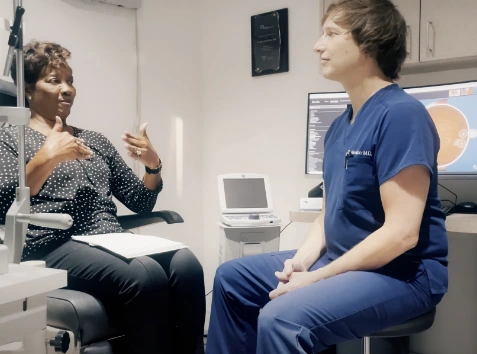 Dr. Rex sitting with cataract surgery patient