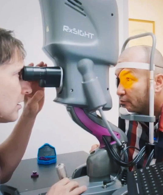 Dr. Rex Hamilton examining patient's eye using RxSight device