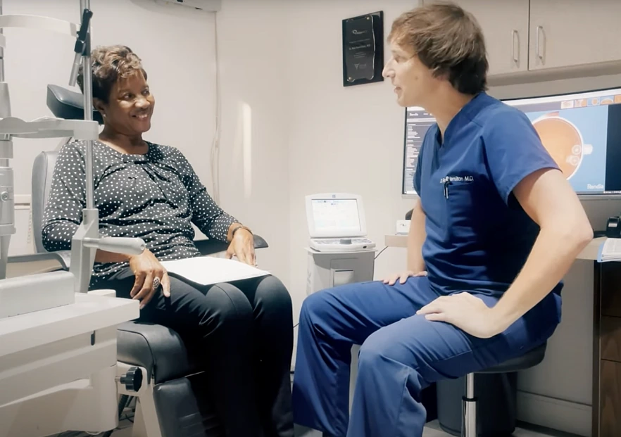 Dr. Rex sitting with cataract surgery patient
