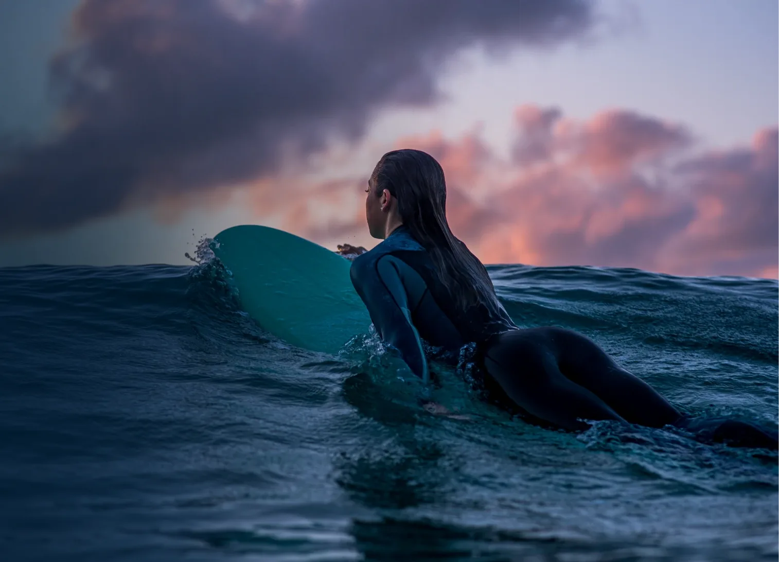 young woman surfing at dusk with clear vision