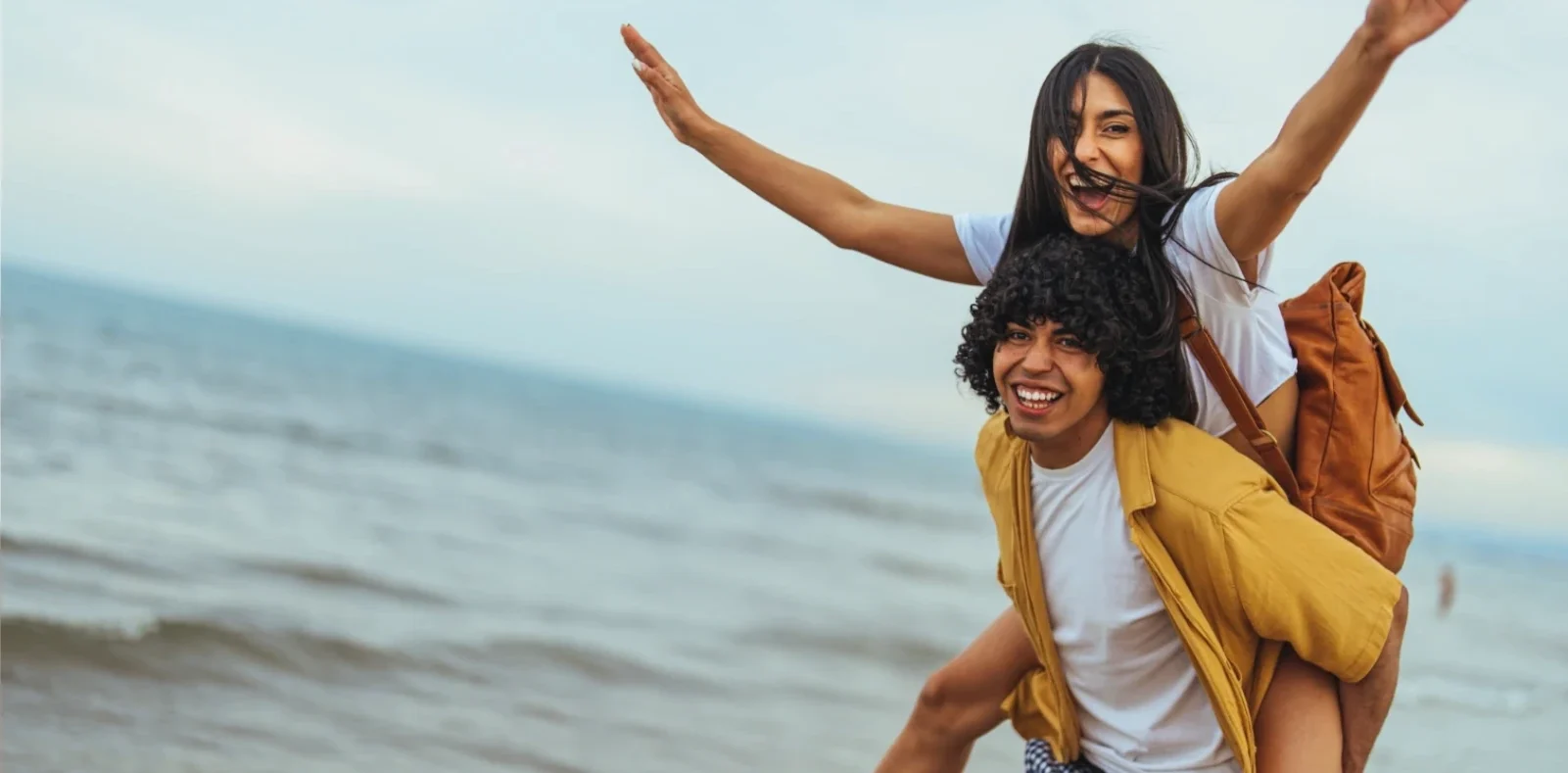 happy youthful couple having fun on beach