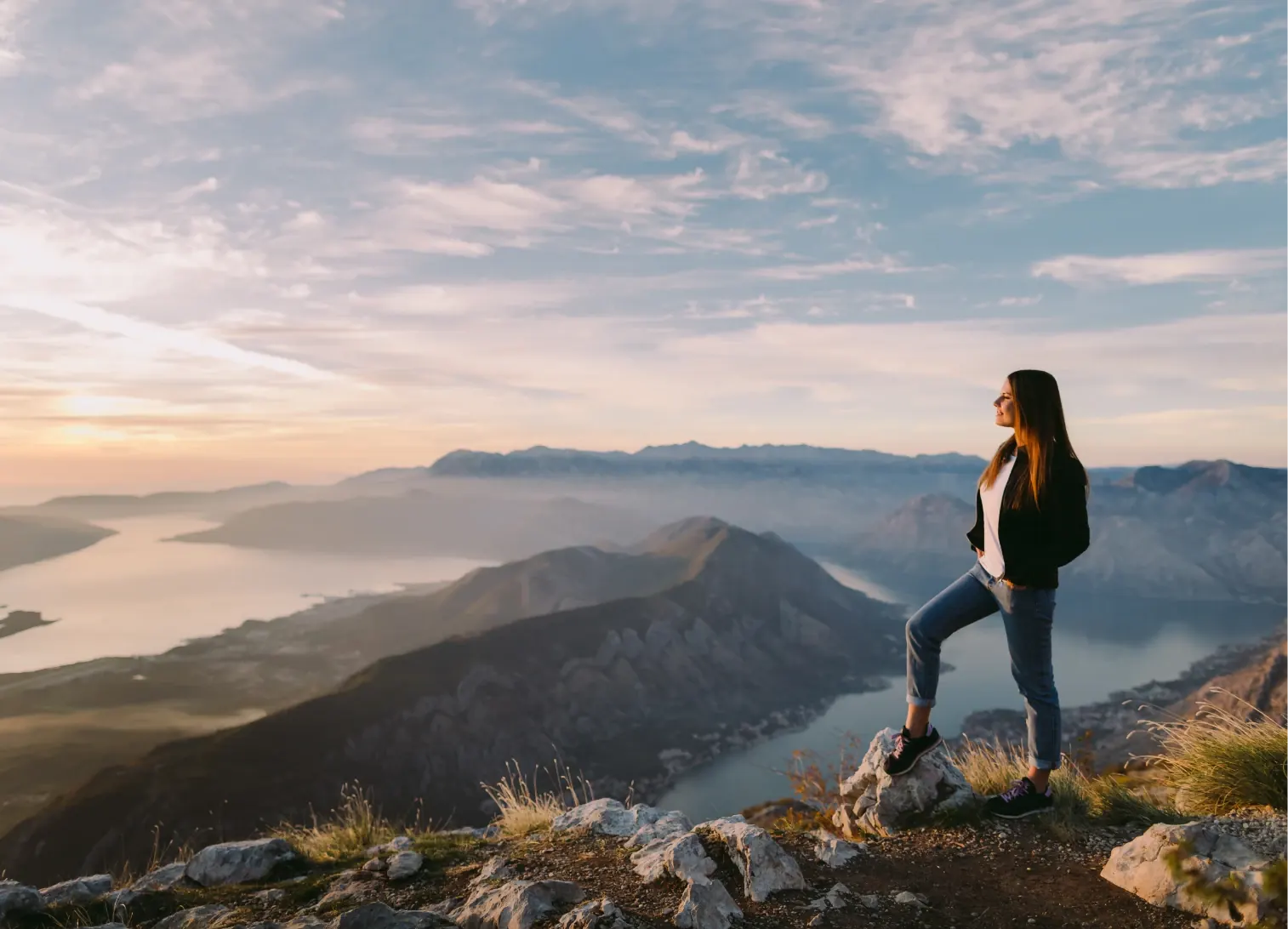 Happy female hiker enjoying beautiful scenic view with clear vision