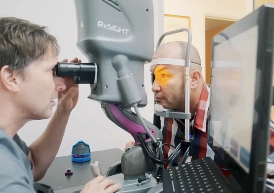 Dr. Rex Hamilton examining patient's eye using RxSight device
