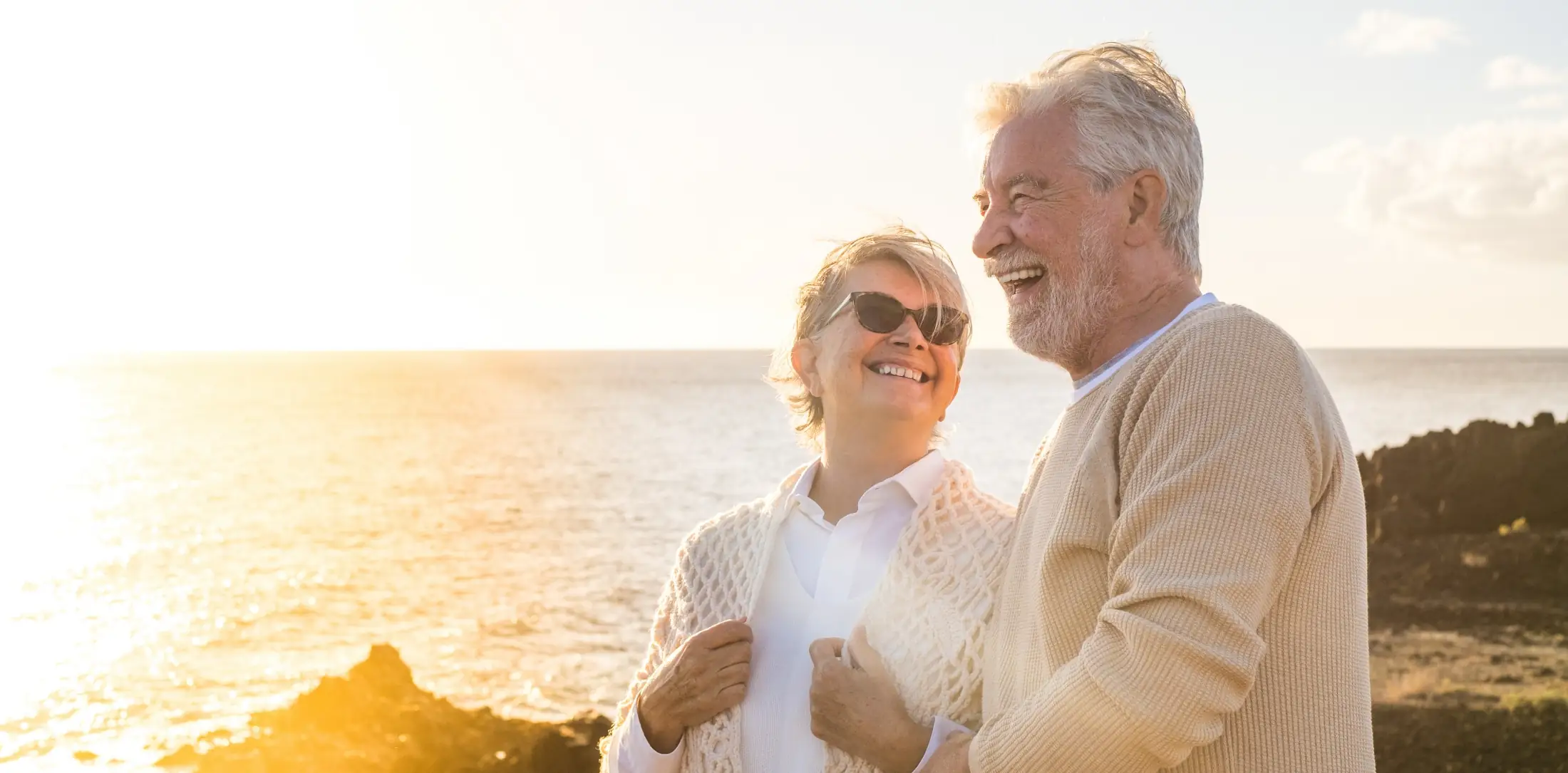 Older couple looking at the sunset after IOL surgery